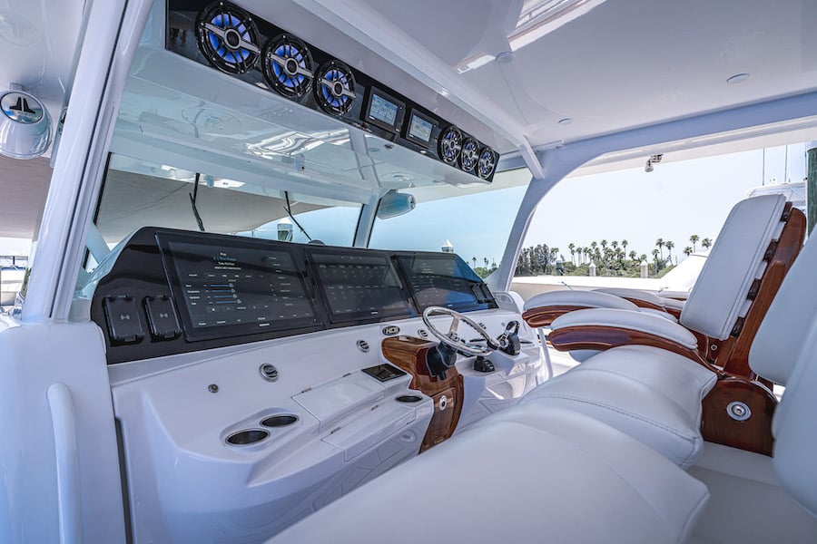 A boat interior featuring a white dashboard with the Engine Cut-Off Switch and steering wheel, adhering to Boat Law regulations.